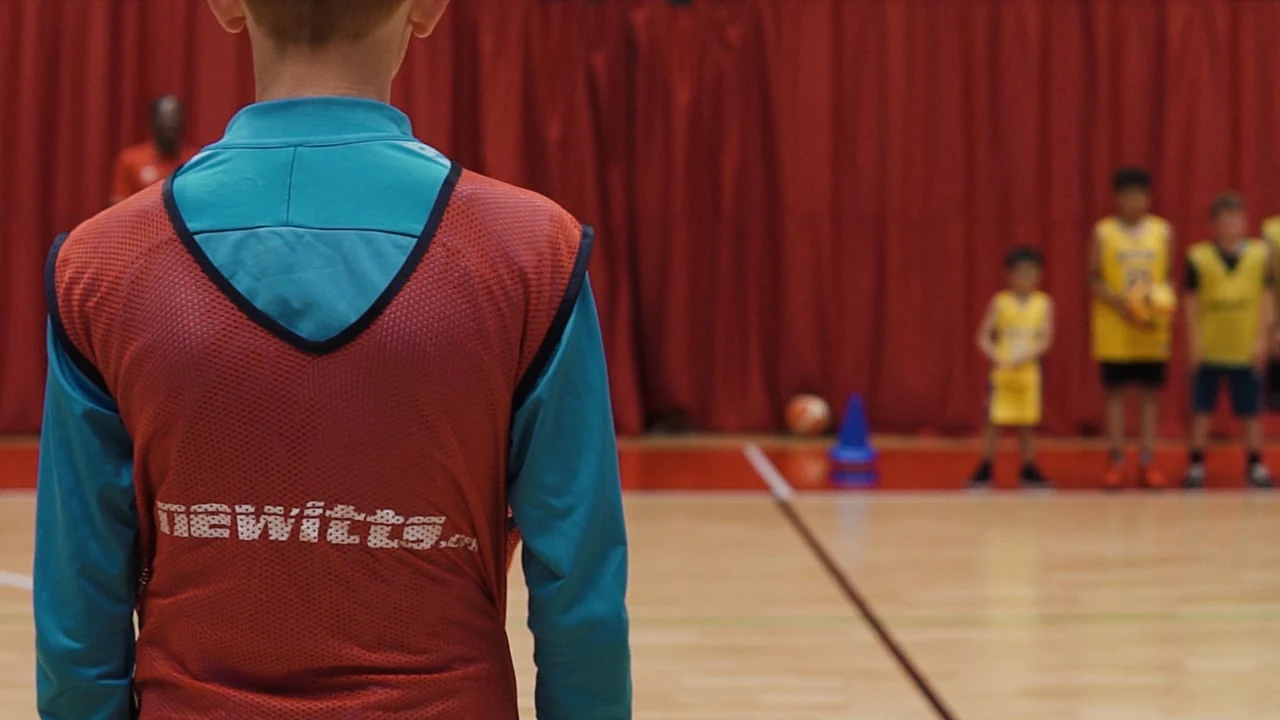 Junior sports participants playing on an indoor court in the Essex Sport film
