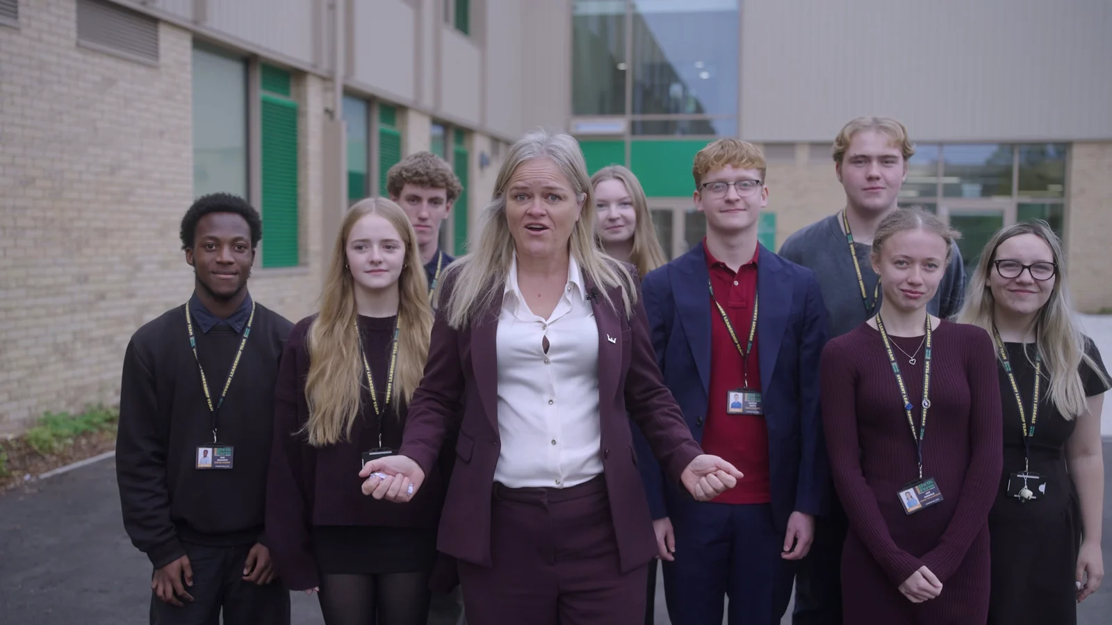 KES staff member and sixth-form students outside the school