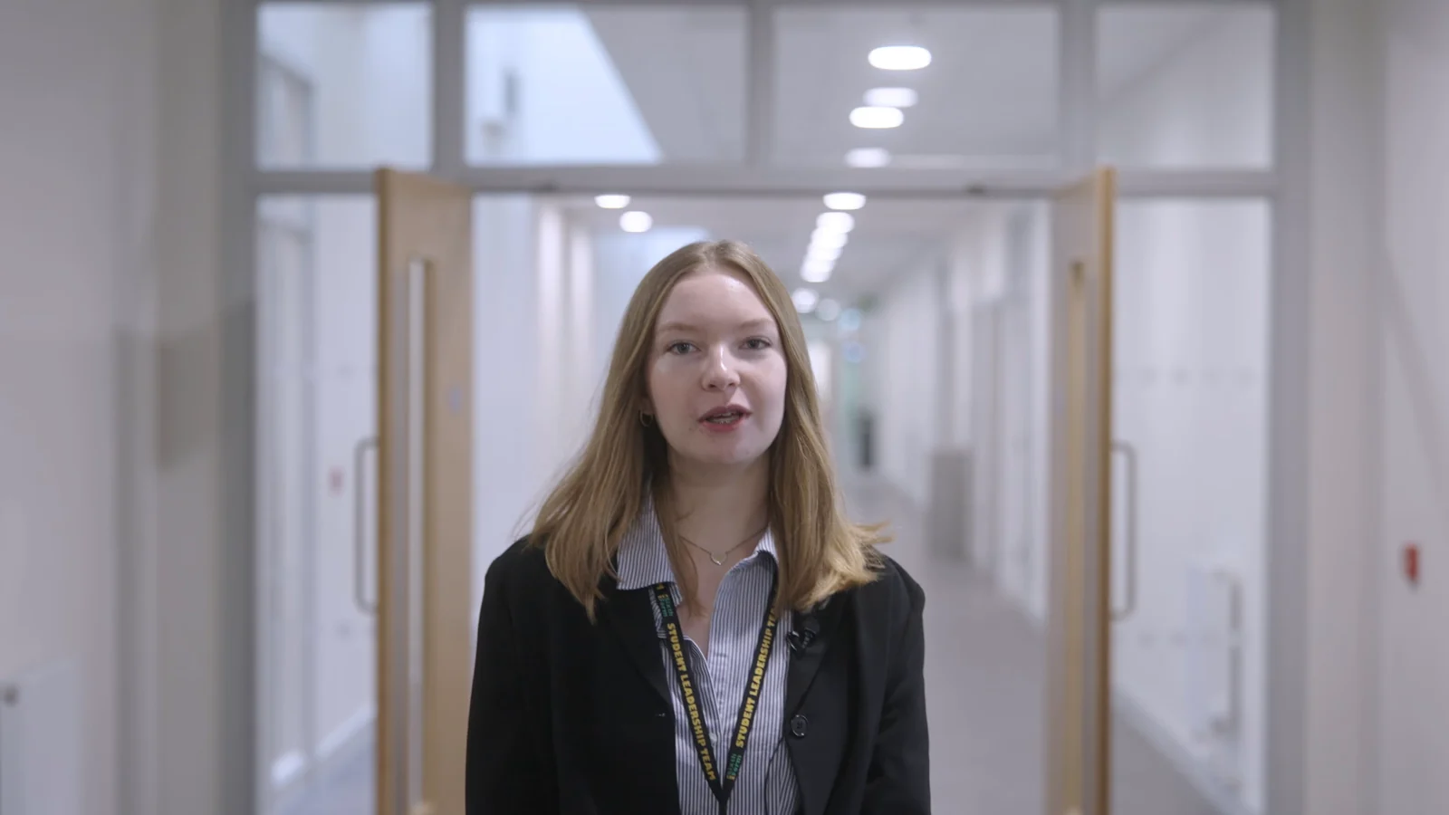 KES student speaking in a college corridor