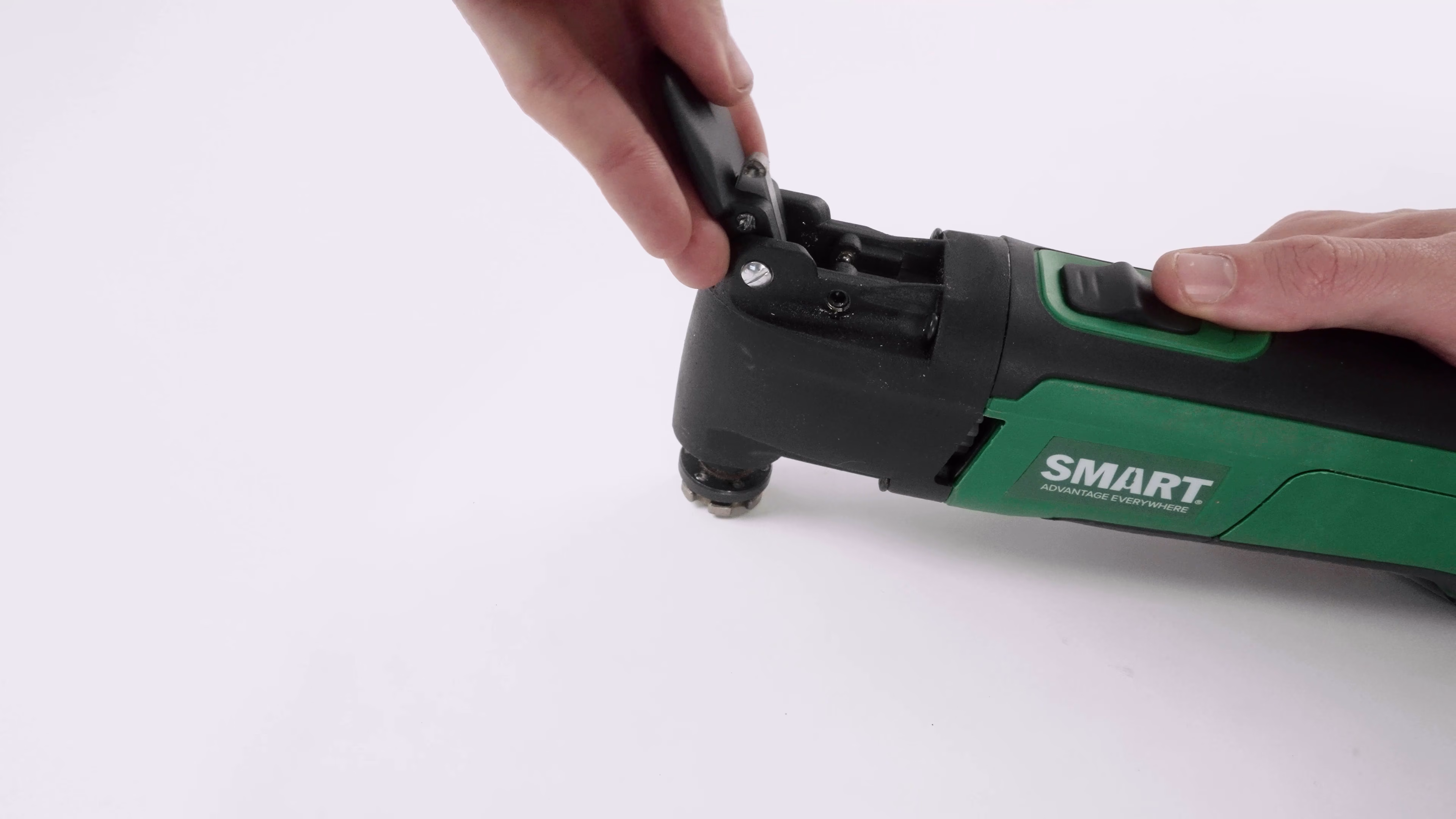 Hands operating the quick-release mechanism on the SMART multi-tool