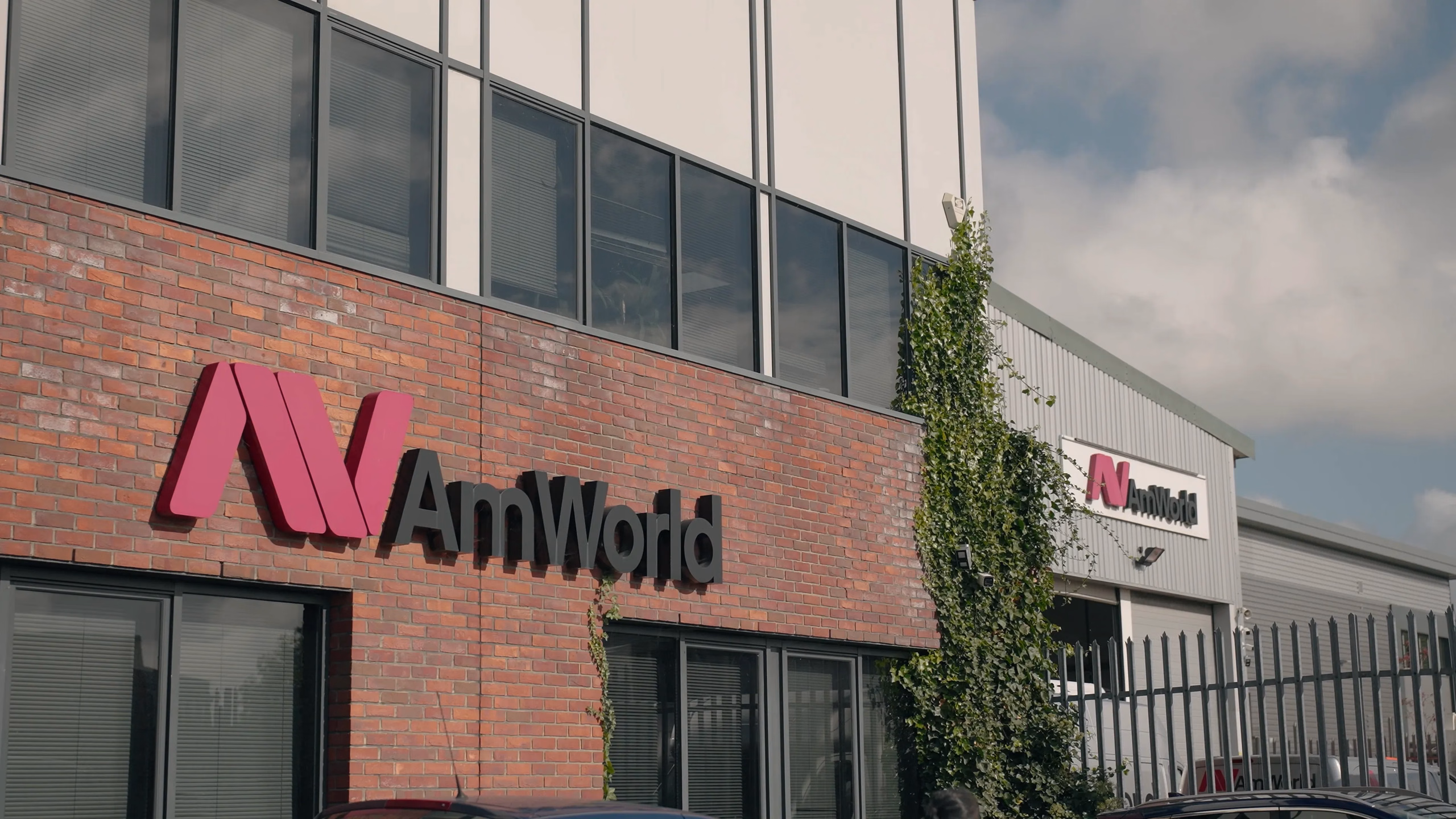 AMWORLD signage on the exterior of its building