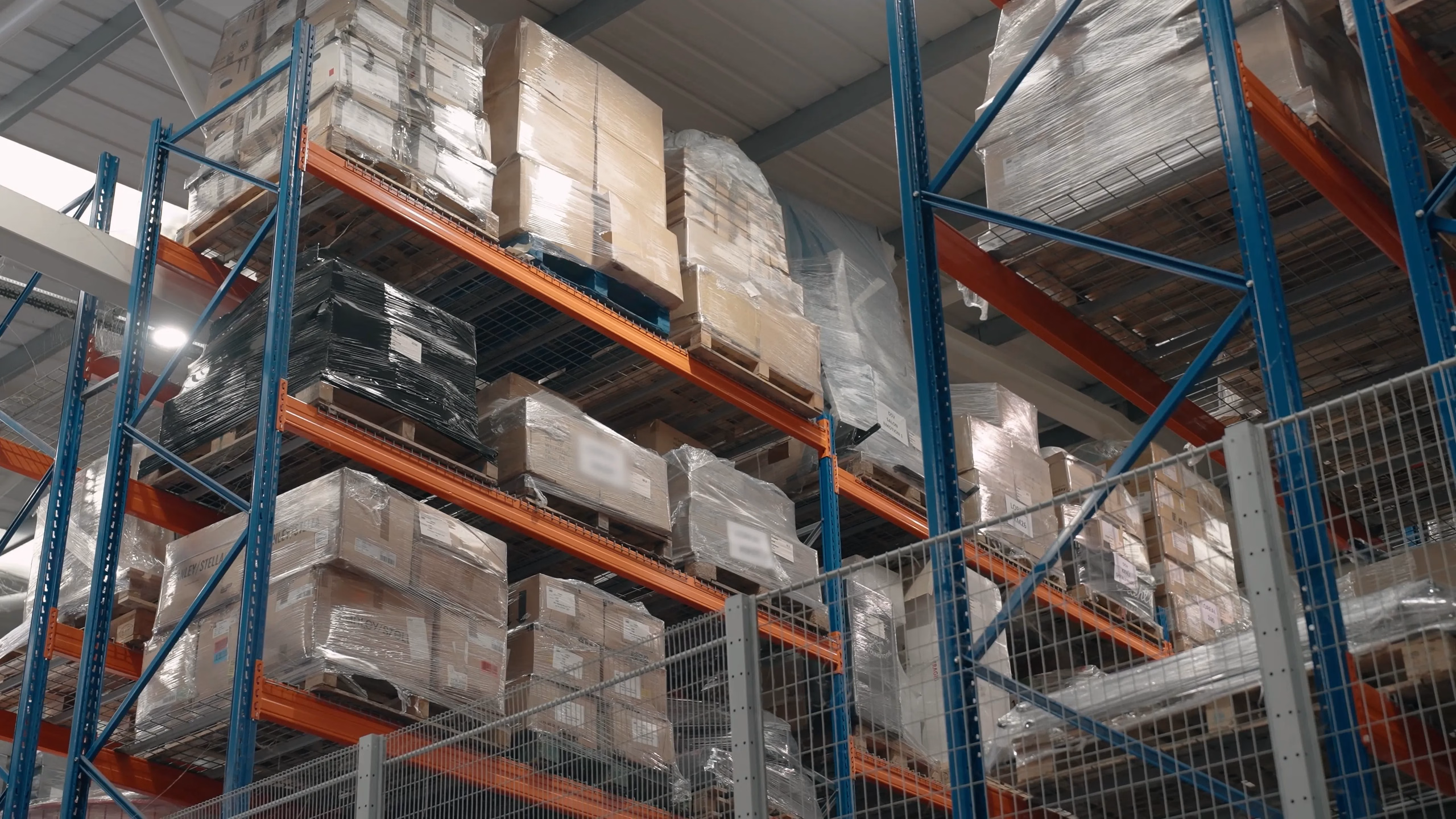 Storage racks and boxed stock in an AMWORLD warehouse