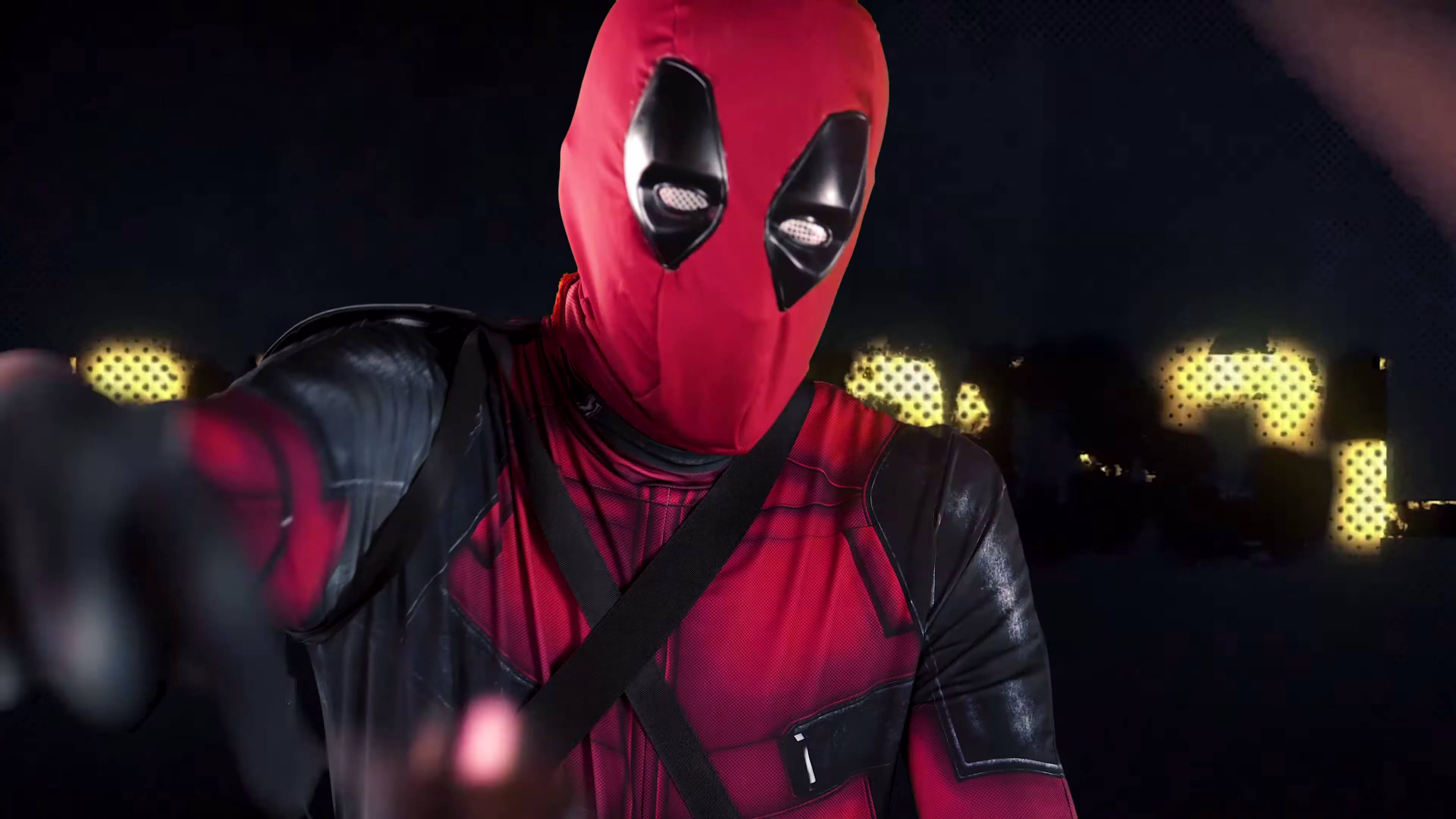 Deadpool reaches towards the camera during his rap verse