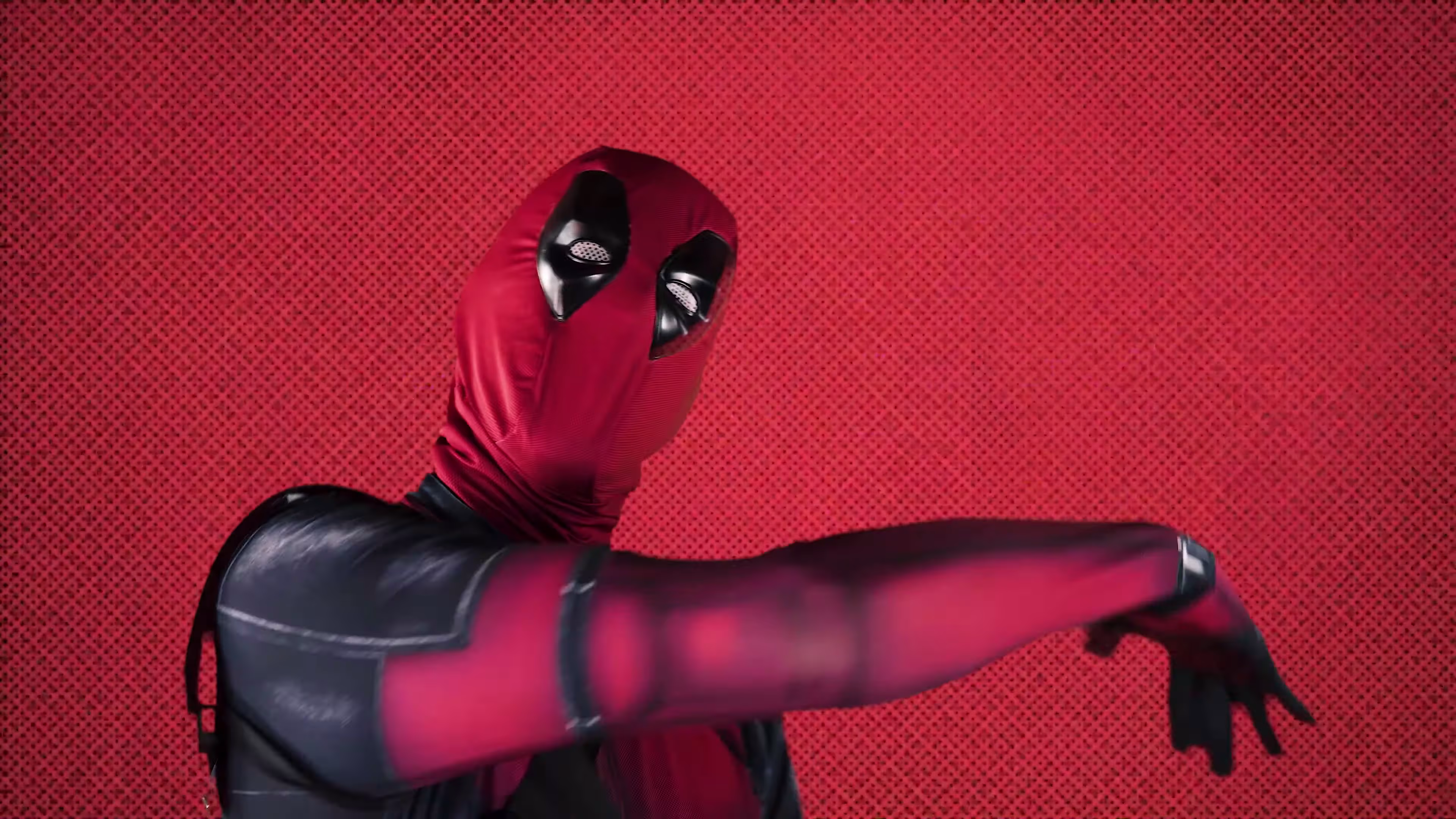 Deadpool gestures across a red halftone comic panel