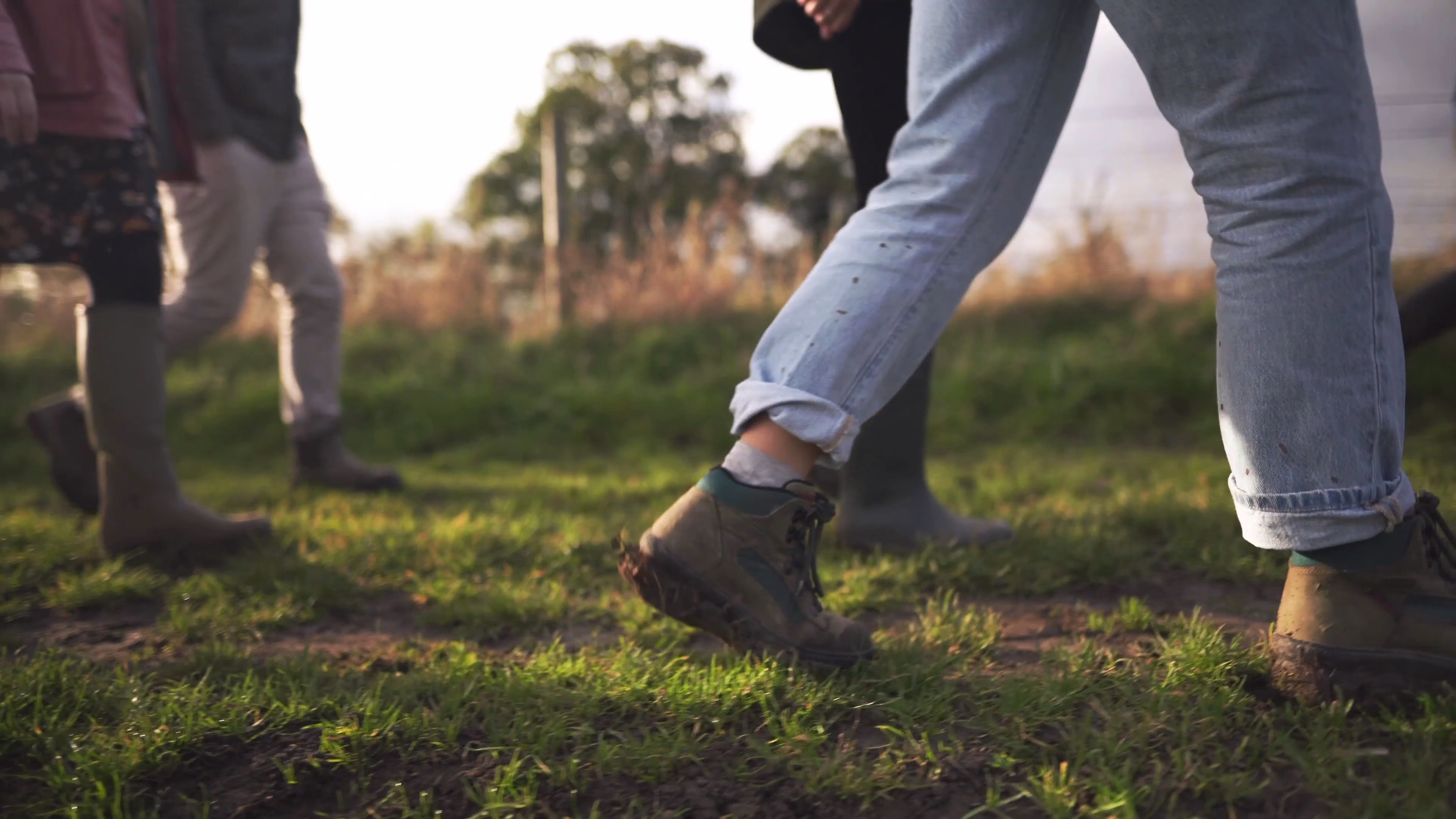 Walking boots crossing the agricultural site during the group tour