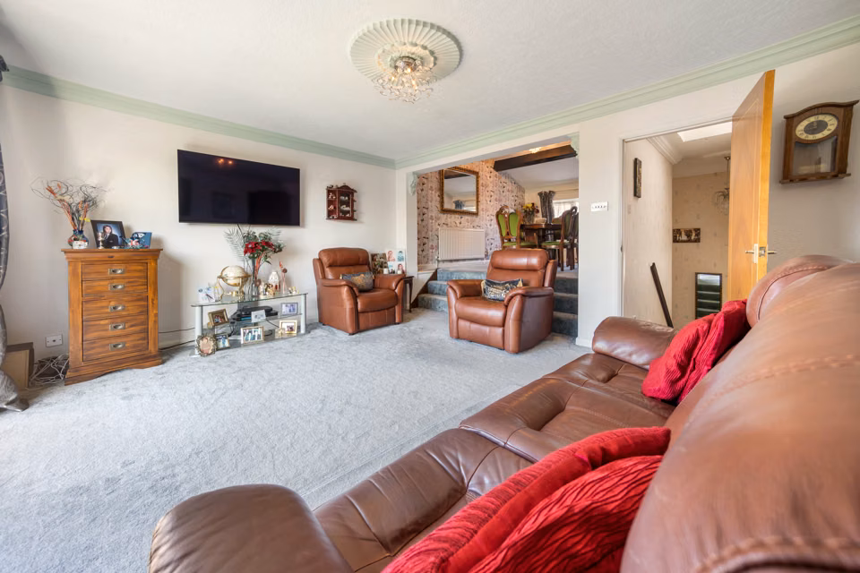Living room seating around a wall-mounted television — 13 Furness Close