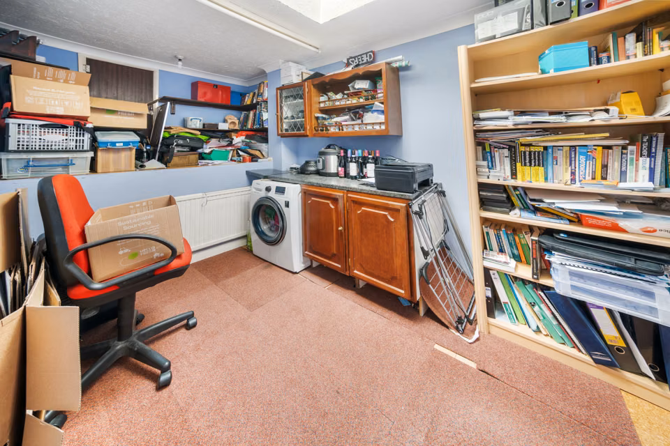 Study and utility room with shelving and a washing machine — 13 Furness Close