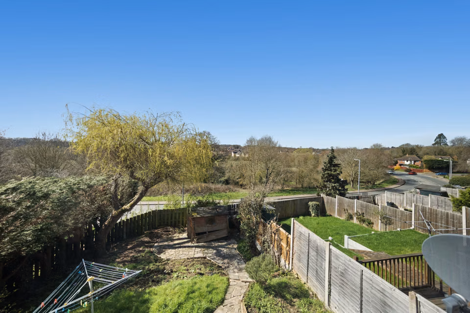 Elevated view over the rear garden and surrounding trees — 13 Furness Close