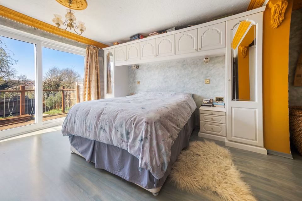 Bedroom with fitted wardrobes and a wide window — 13 Furness Close