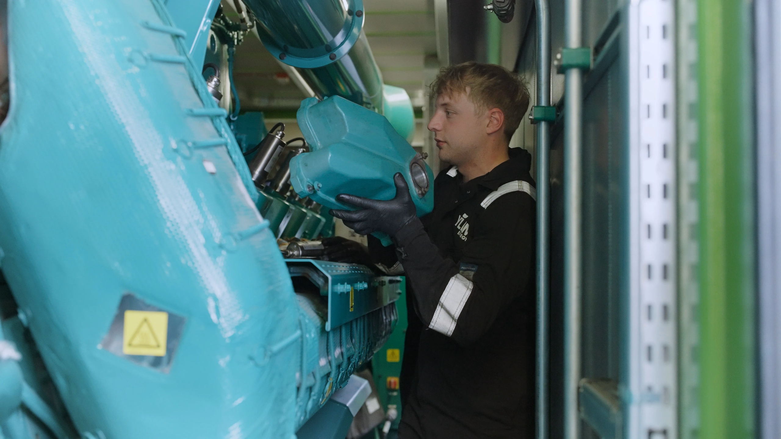 YLEM engineer working on a Cummins generator at Terra Firma