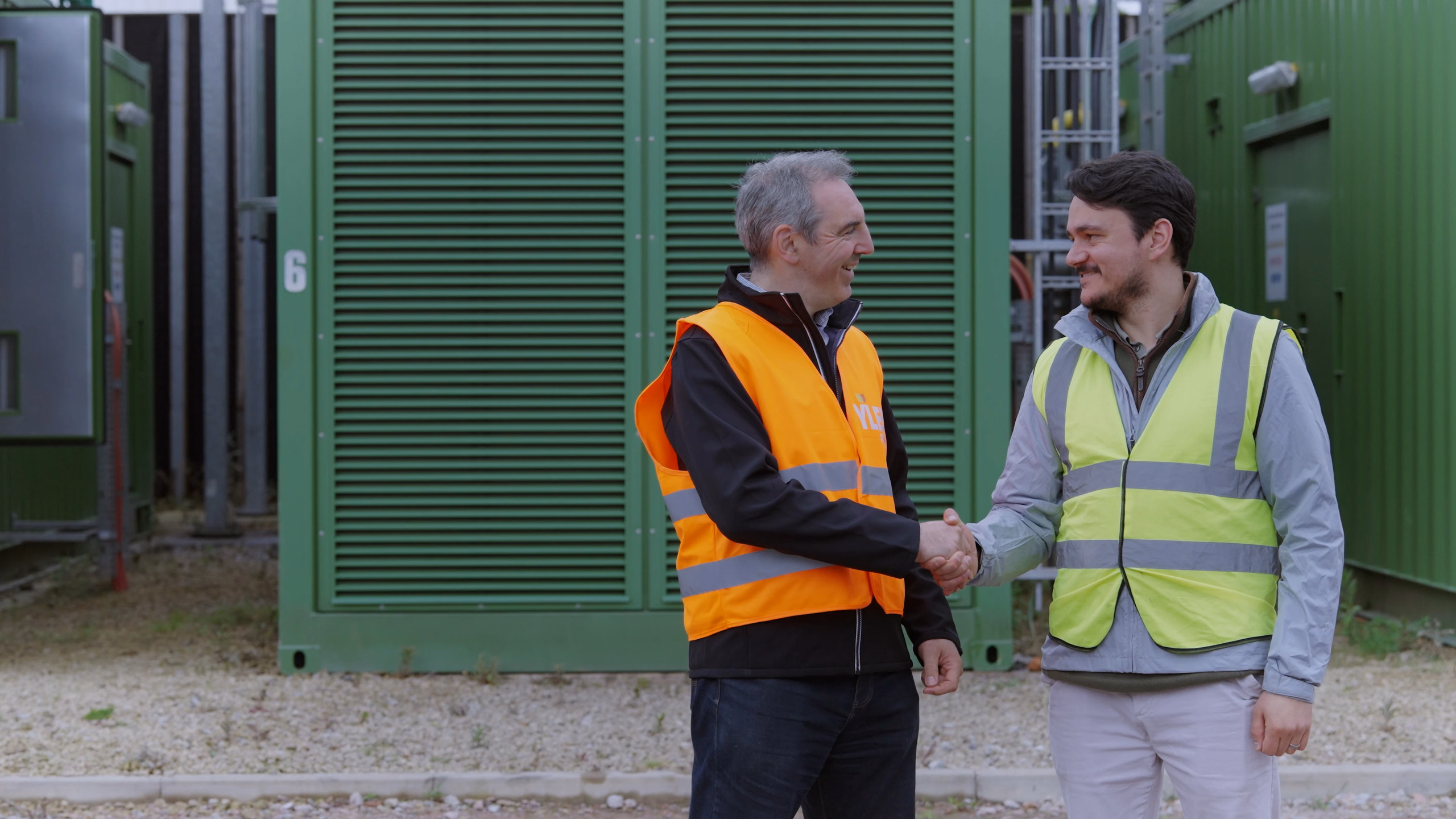 YLEM and Terra Firma representatives meeting beside the generator enclosures