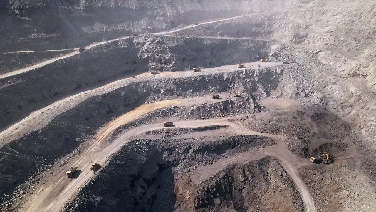 A terraced open quarry with haul roads seen from above