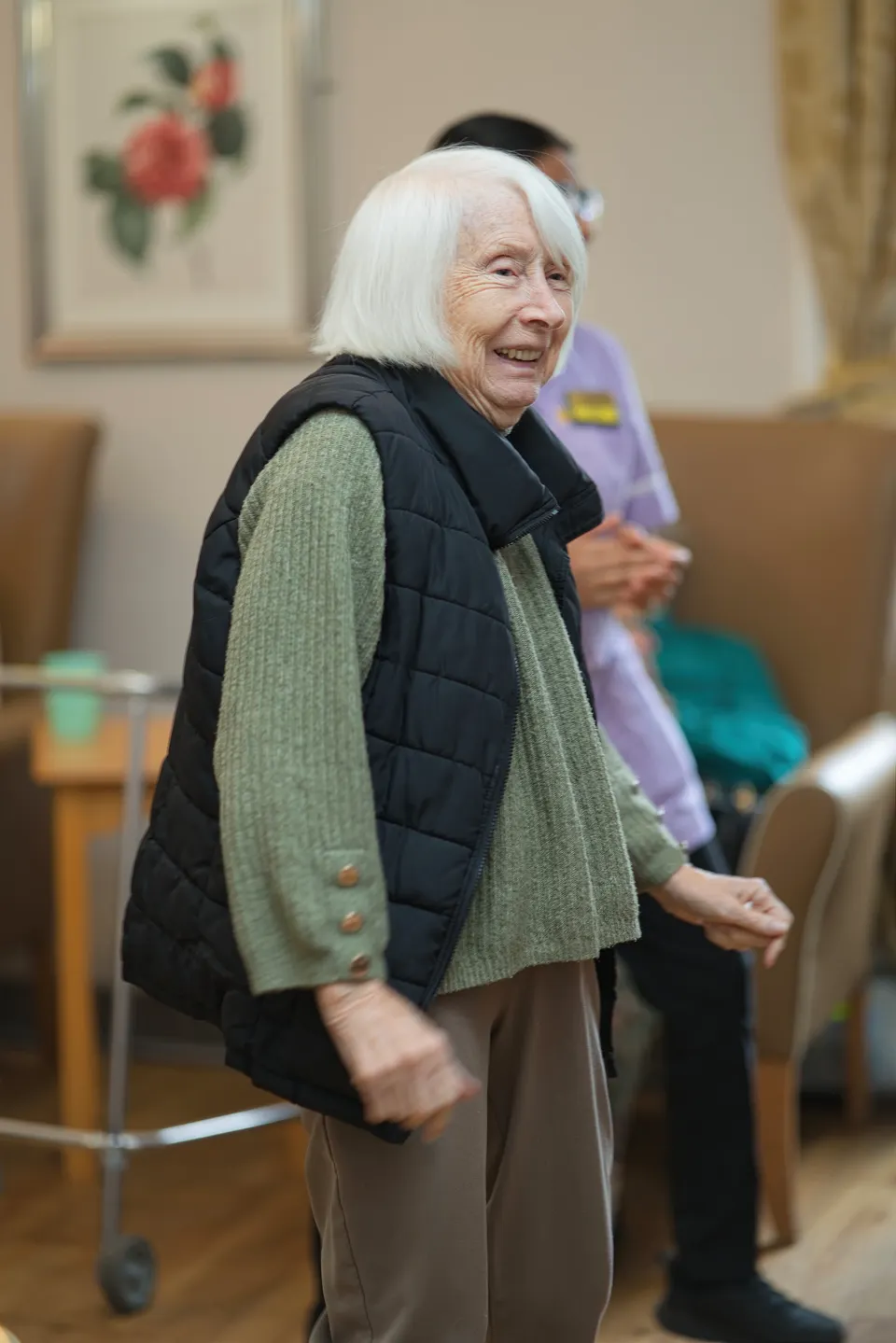 A resident smiling during the living-room activities