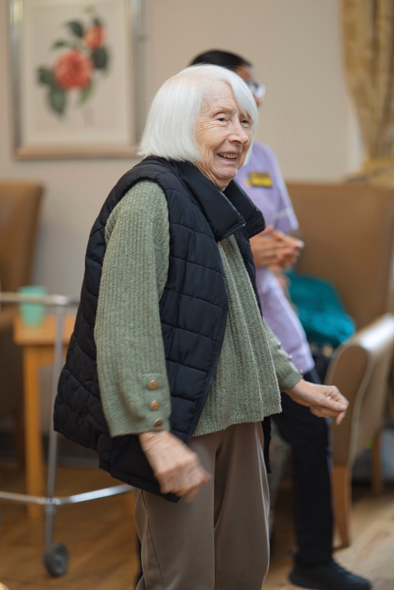 A resident smiling during the living-room activities