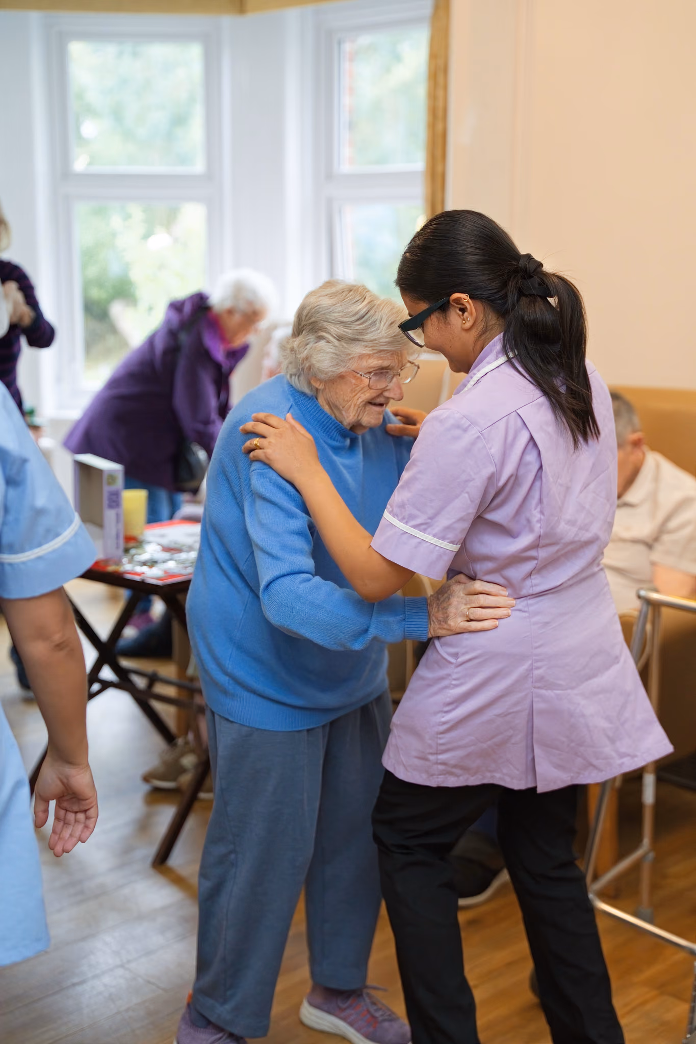 A carer and resident sharing a close moment during dancing