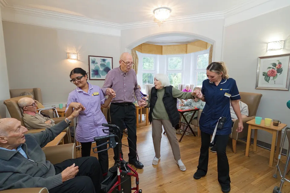 A wide view of dancing and shared activities in Eastham’s living room