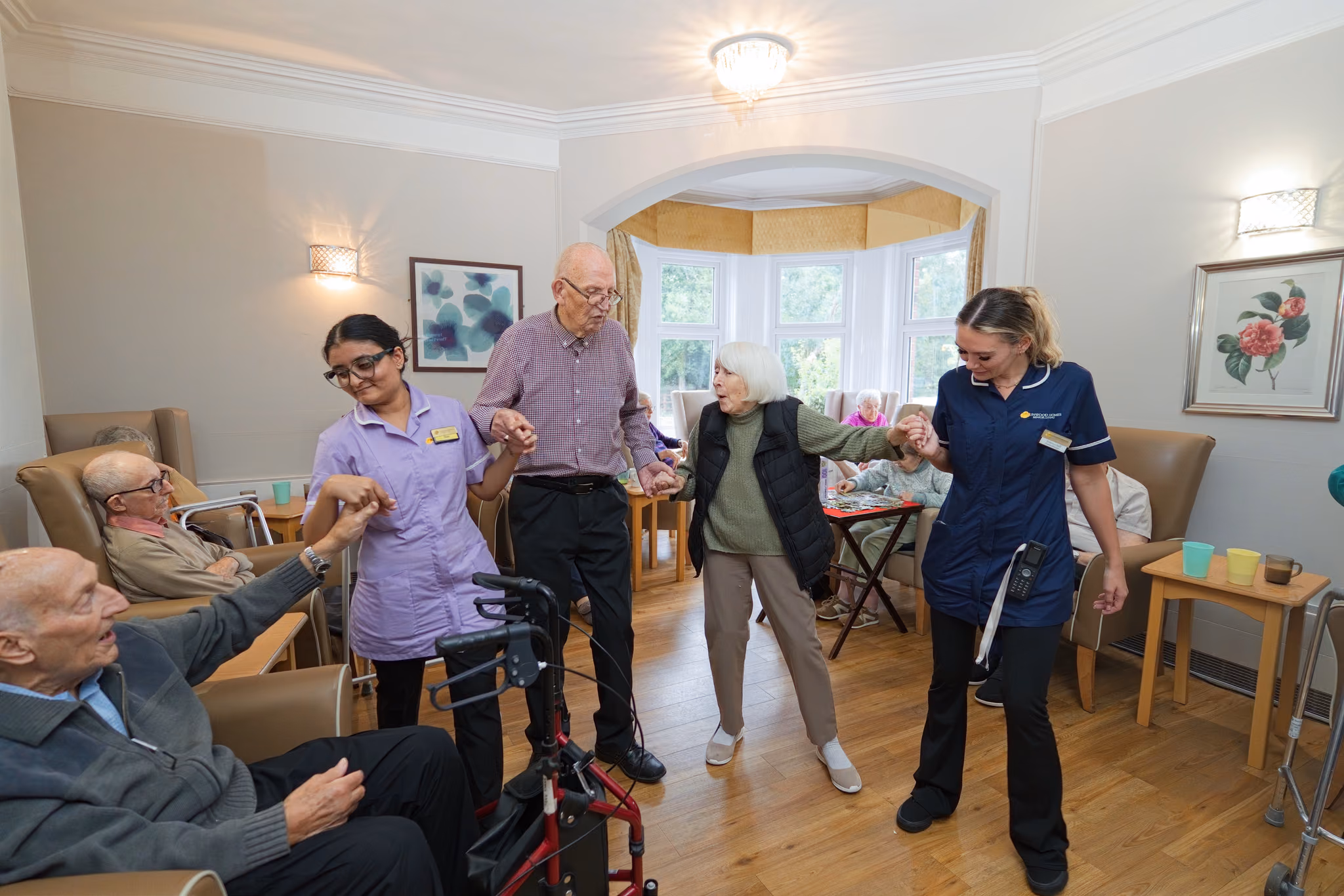 A wide view of dancing and shared activities in Eastham’s living room