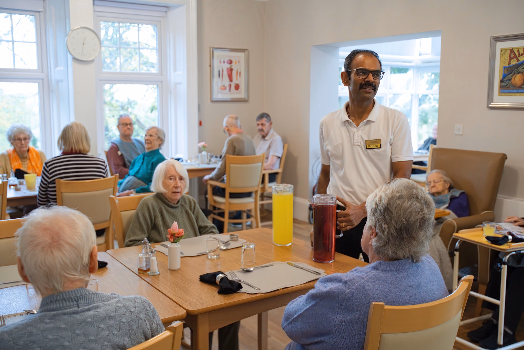 Residents and a staff member gathered in Eastham’s dining room