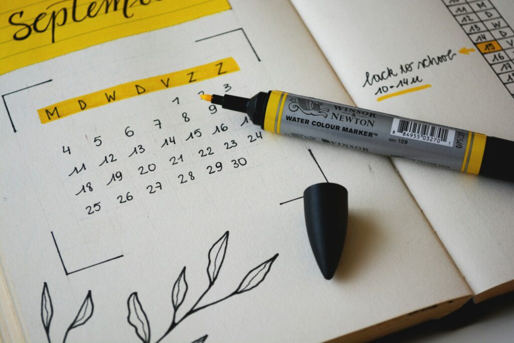 A monthly planner page with a pen, ready for planning content