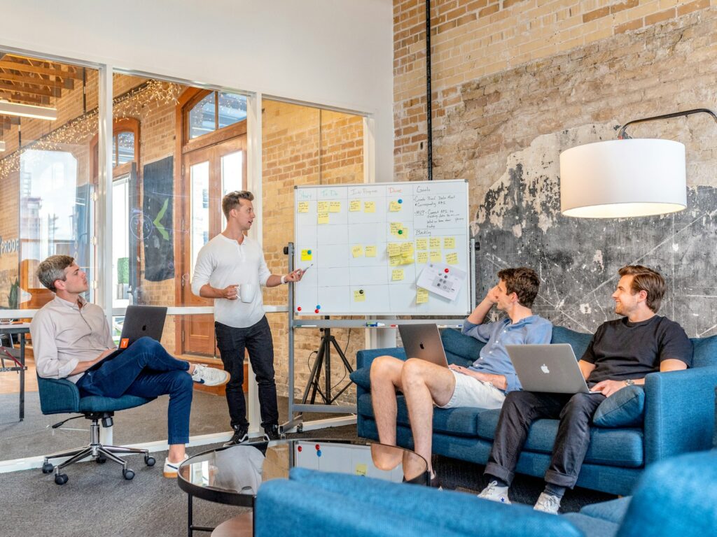 A small team planning around a whiteboard of sticky notes