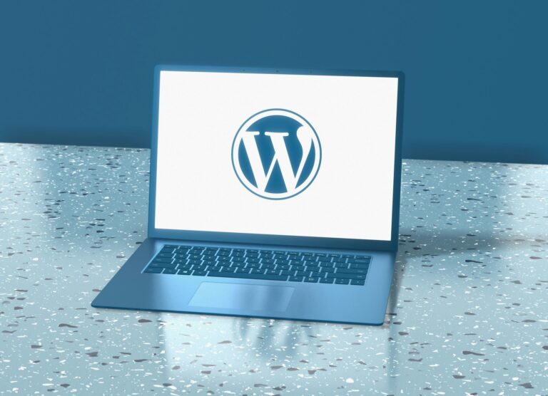 A laptop showing the WordPress logo on screen