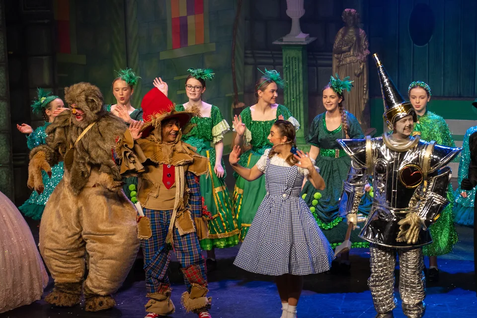 The Wizard of Oz cast performing on stage for Polkadot Pantomimes