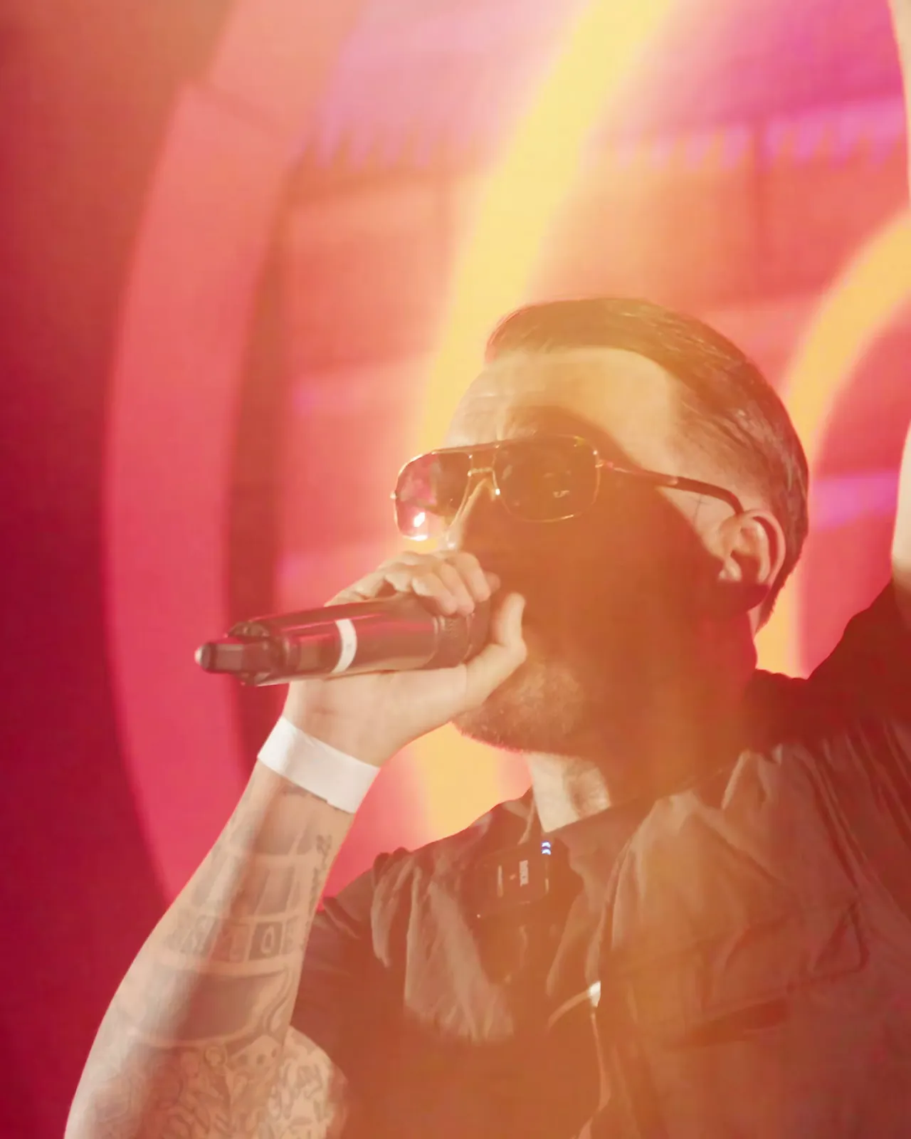 Artist performing under red stage lights