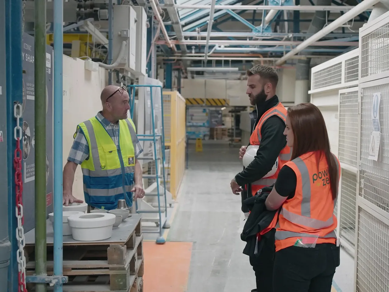 Staff in conversation on the factory floor