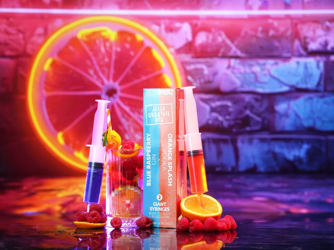 Jellyshotz range arranged beside a neon orange slice