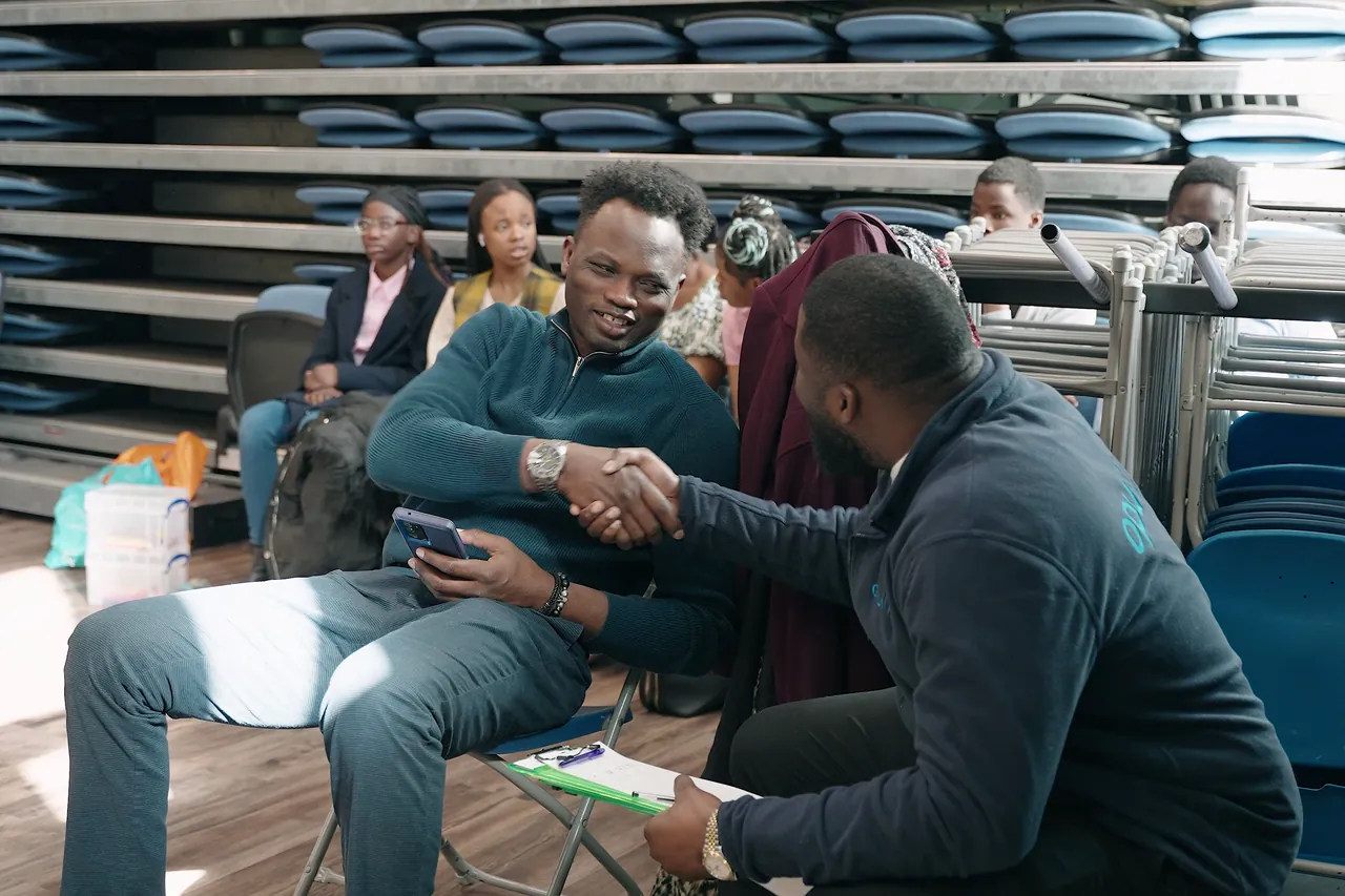 Opul Life team member shaking hands with a visitor