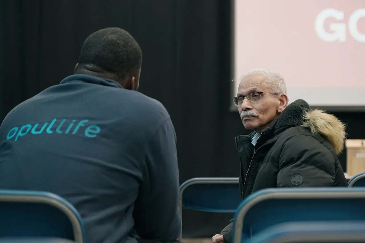 Team member listening to an older visitor