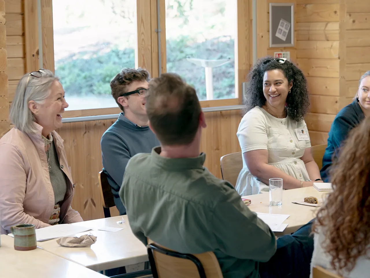 Workshop guests in conversation around a table
