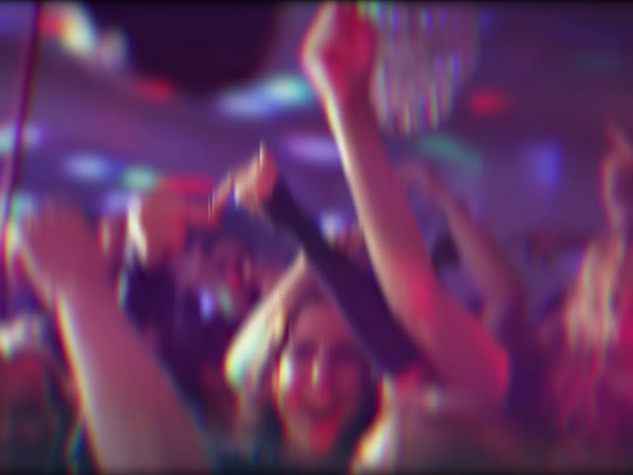 Dancers blurred by coloured lights