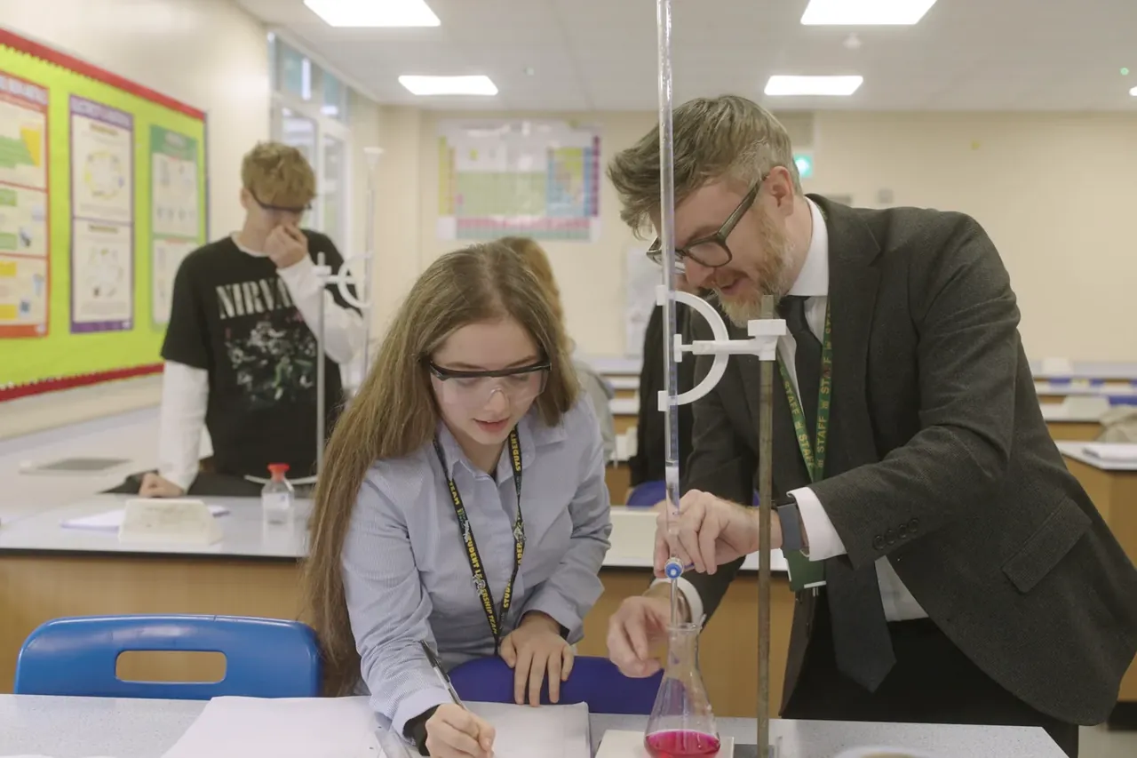 Teacher guiding a chemistry lesson