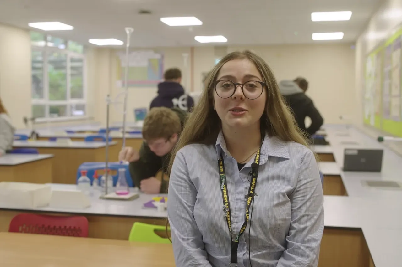 Student speaking in a science classroom