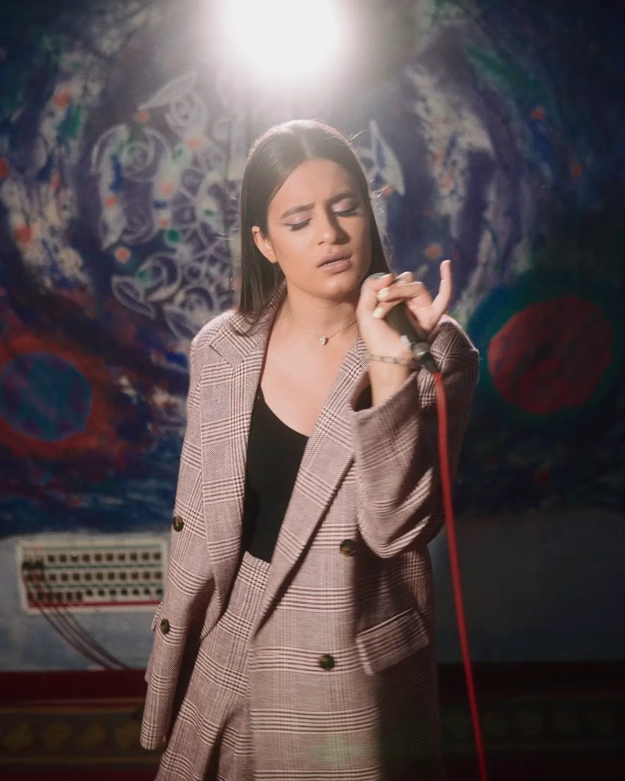 Wide shot of the singer in the studio