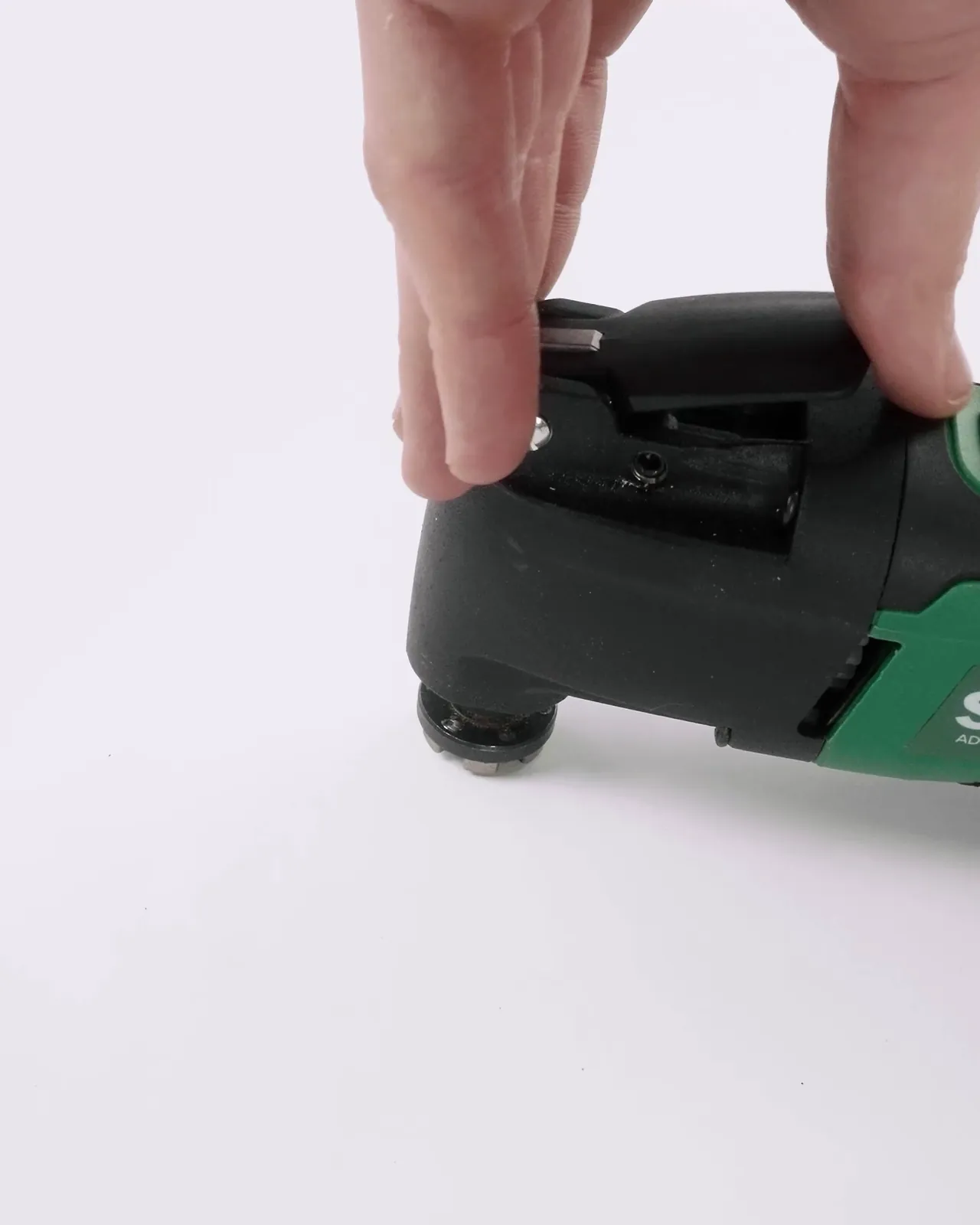 Hands fitting a blade to the multi-tool