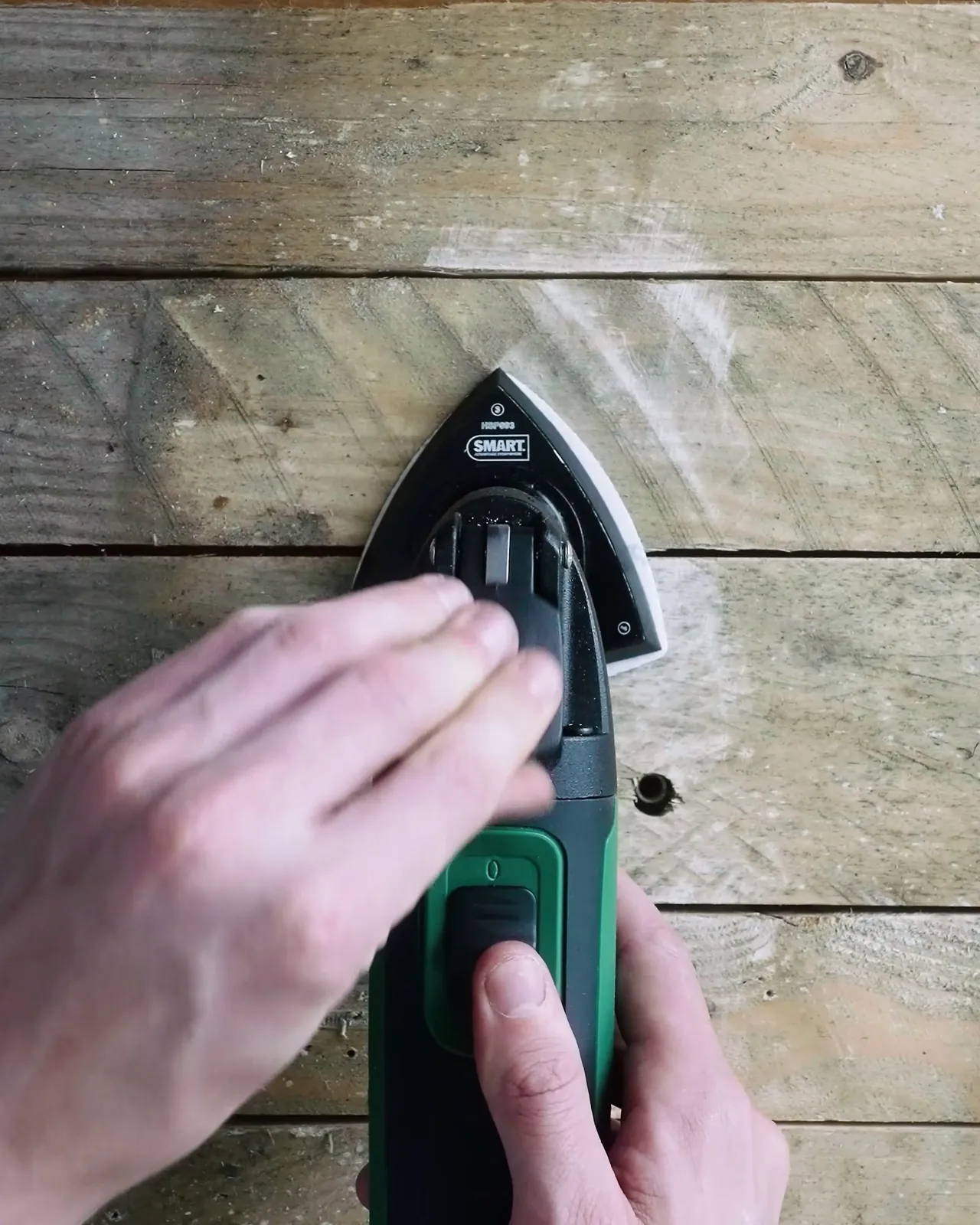 Sanding a weathered wooden board