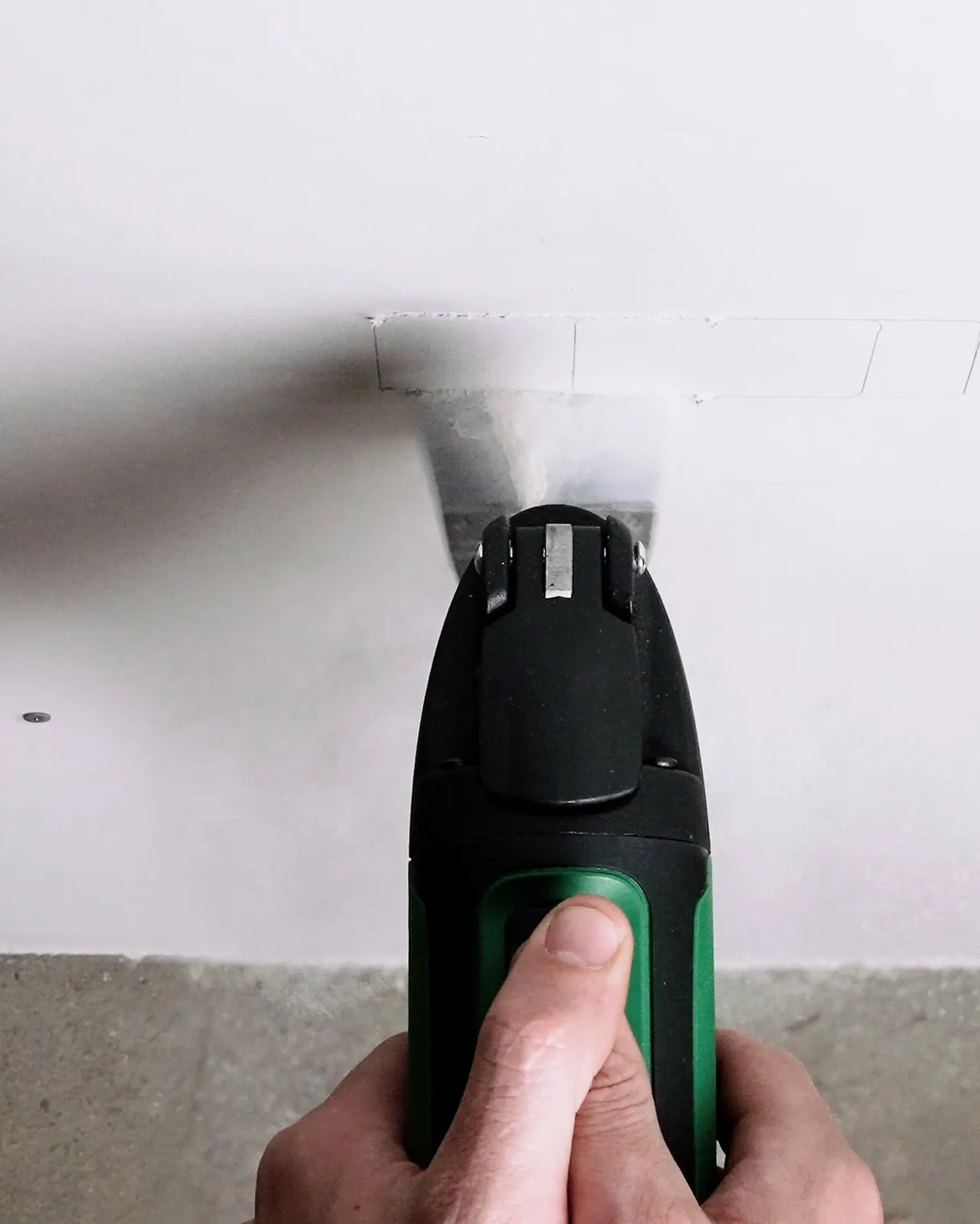 Working on a plaster wall with dust in the air