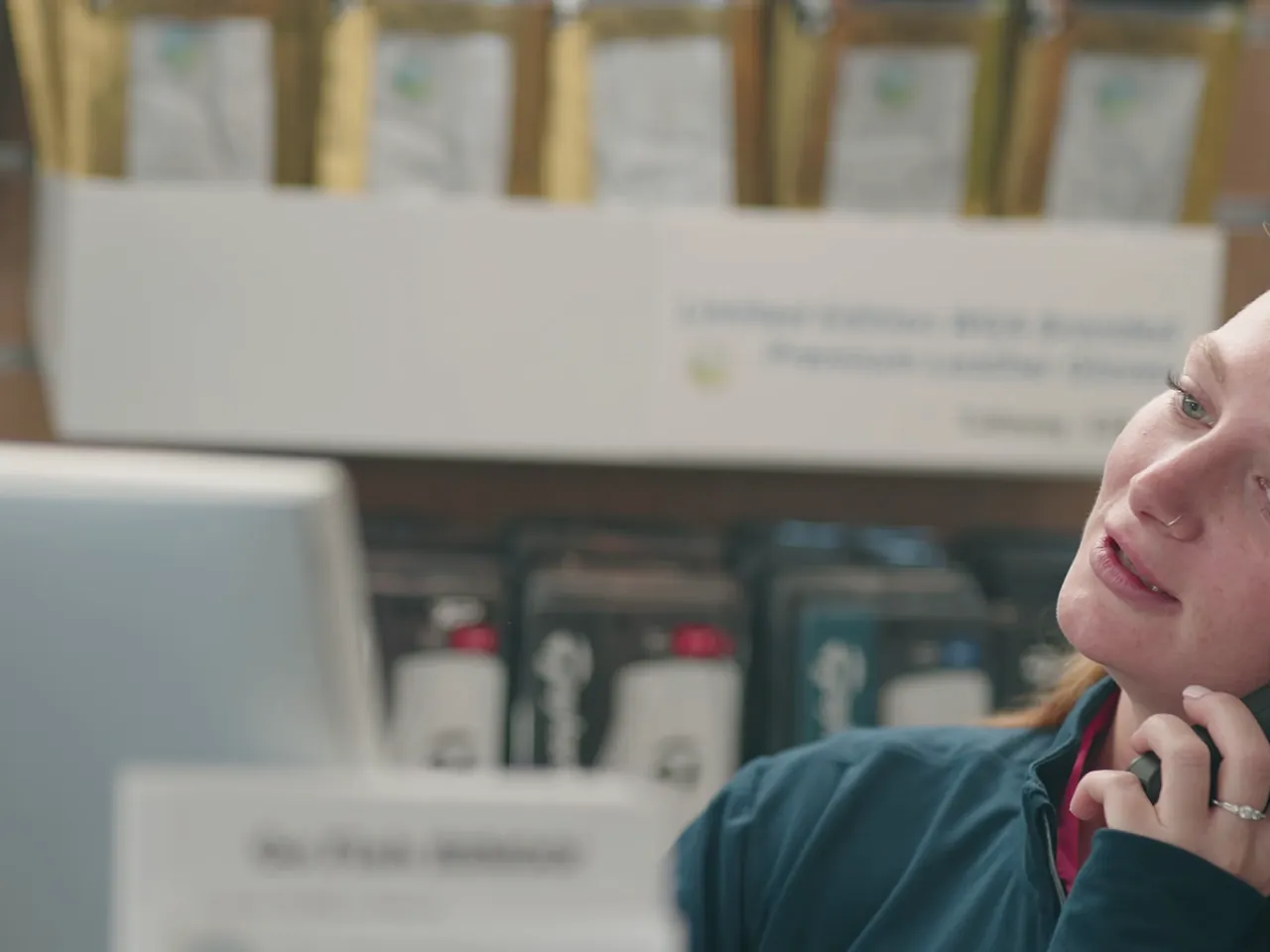Staff member answering a call at the counter