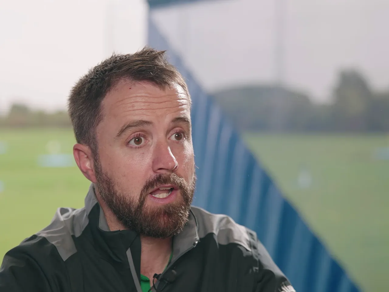 Academy director interviewed beside the driving range