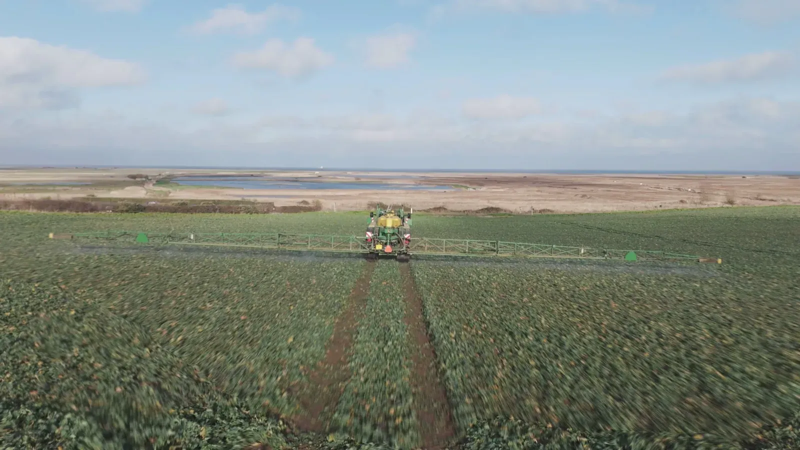 Aerial view of a tractor spraying a field
