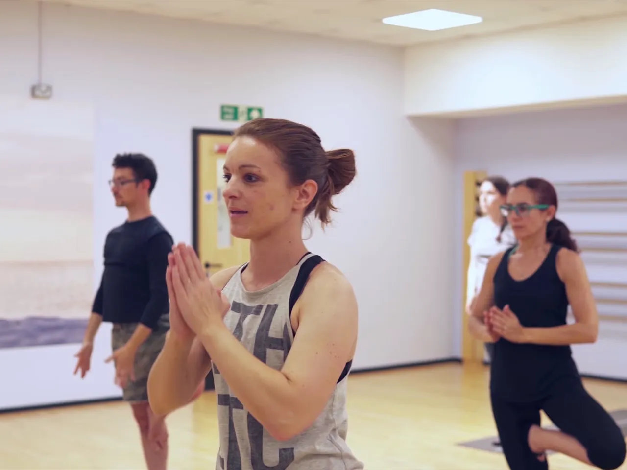 Instructor demonstrating a balance to a yoga class