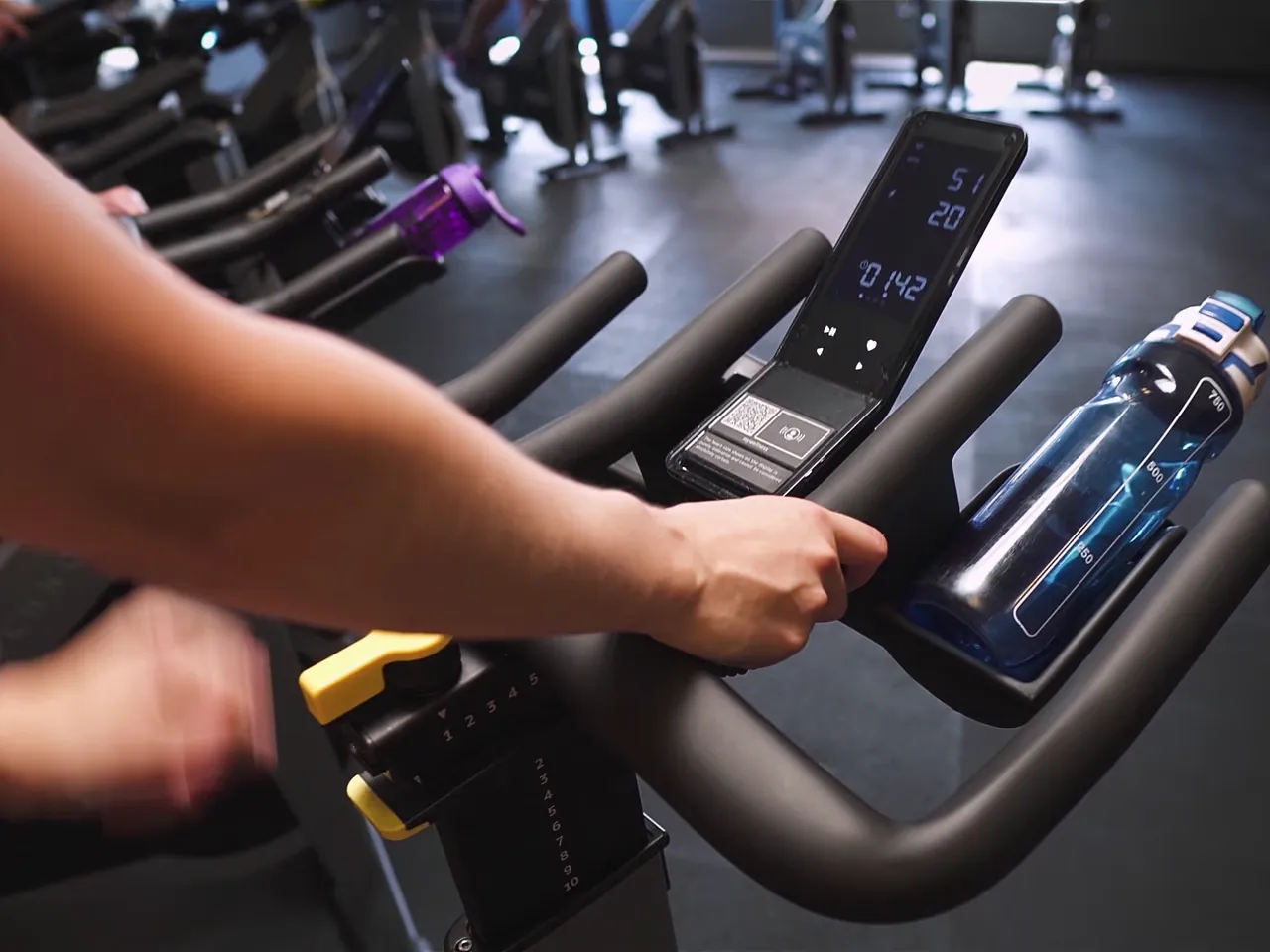 Hands on an indoor cycle console