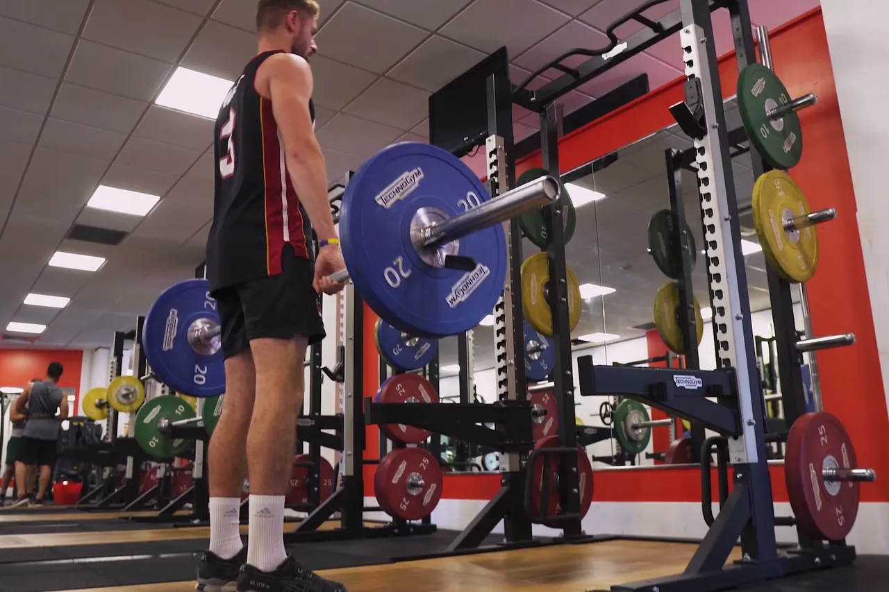 Athlete loading a barbell in the gym