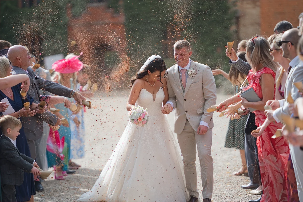 Androulla and Kieran walking through confetti