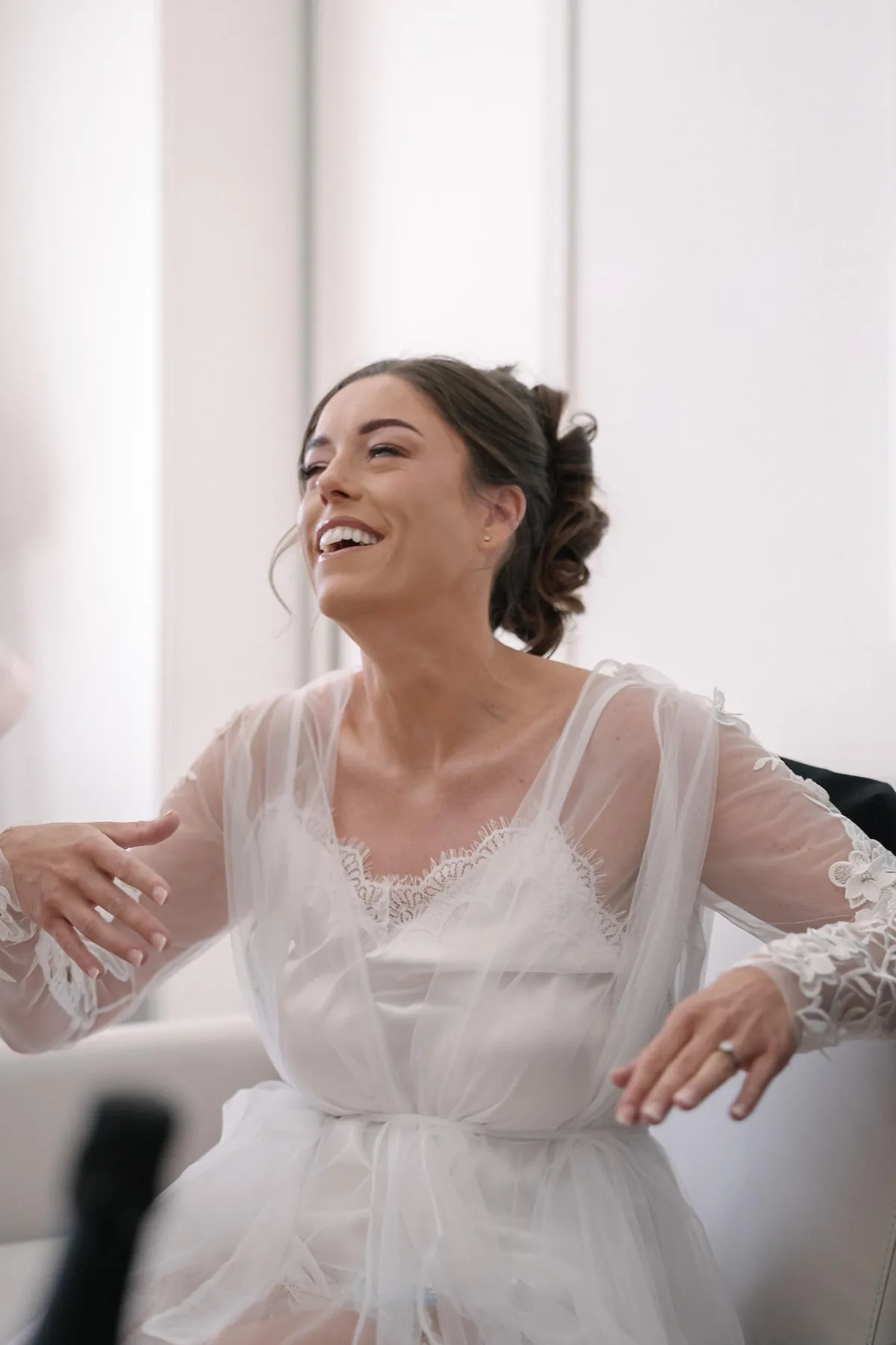 Ellie laughing as she gets ready on her wedding morning