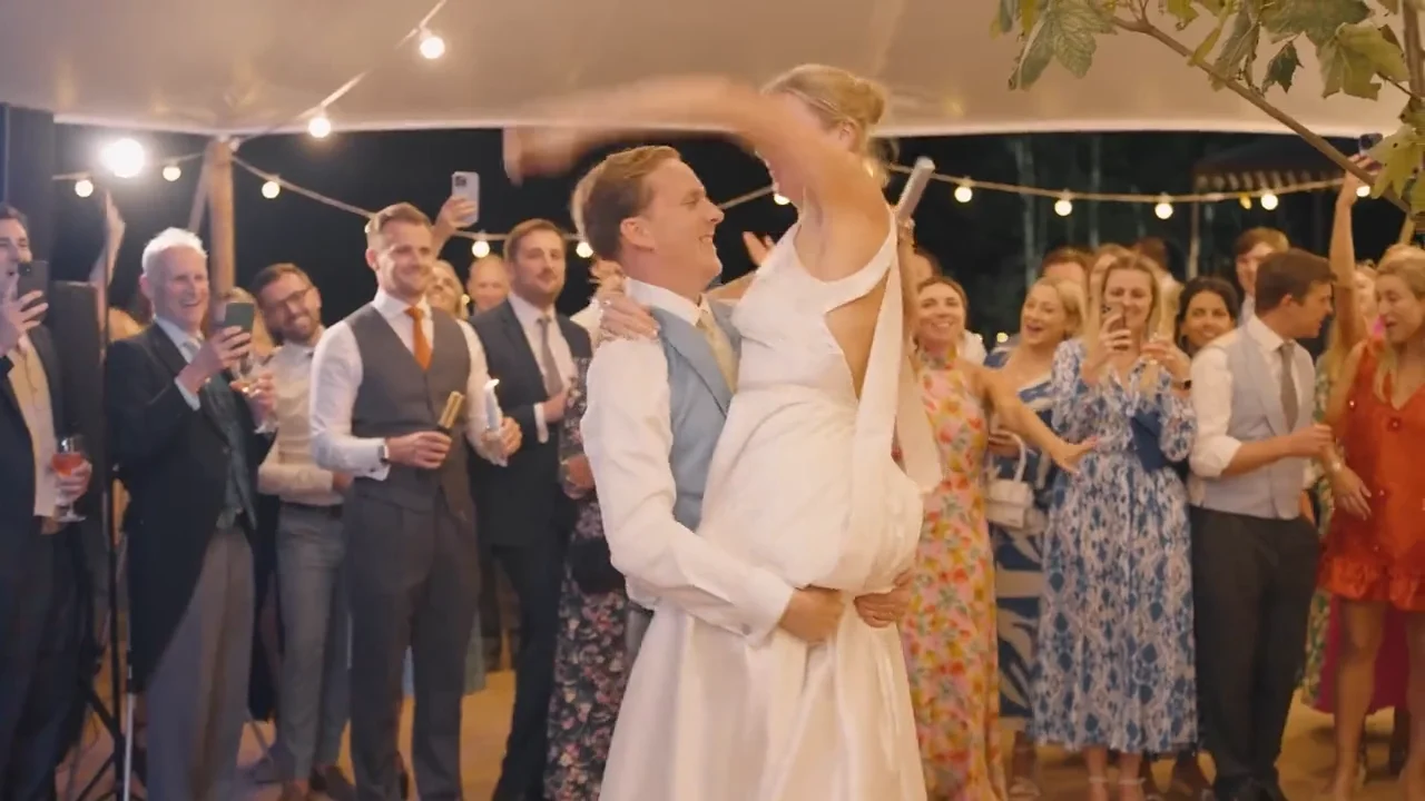 Harriet and Luke dancing together, a still from their wedding film