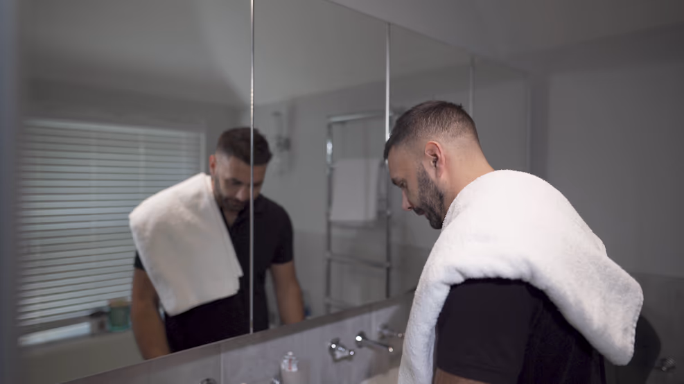 Jake Aldridge facing his reflection in Rather Be Me