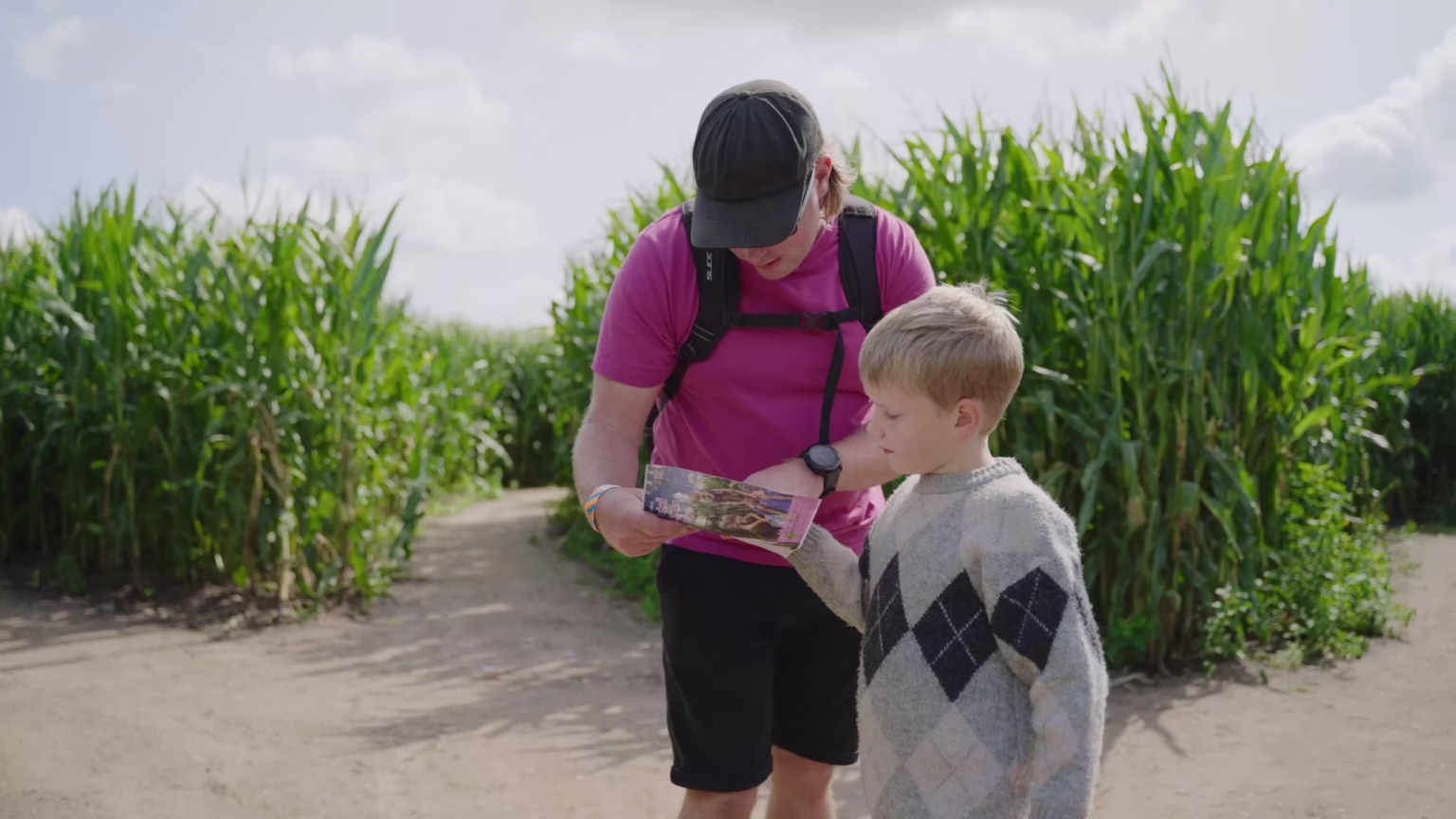 Family using a map inside Southwold Maize Maze